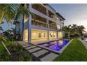 Modern waterfront home with an outdoor patio, pool, and stylish landscaping at 2081 Michigan Ne Ave, St Petersburg, FL 33703