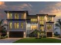 Beautiful modern home featuring clean lines, large windows, and manicured lawn at 2081 Michigan Ne Ave, St Petersburg, FL 33703