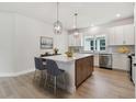 Bright kitchen featuring a center island, modern appliances, pendant lights, and ample cabinet space at 687 Allora Ave, Nokomis, FL 34275