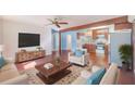 Bright living room with hardwood floors, comfortable seating, and an open floor plan into the kitchen at 21 Belle Meade Cir, Largo, FL 33770