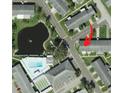 Overhead view of property and surrounding neighborhood with pool and pond at 5006 Springwood N Ave # 119, Pinellas Park, FL 33782