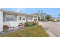 Charming single-story home with well-manicured front yard and covered entrance at 5006 Springwood N Ave # 119, Pinellas Park, FL 33782