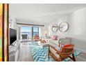 Bright living room with modern decor and access to waterfront patio at 6265 Sun Blvd # 101, St Petersburg, FL 33715
