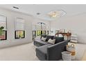 Bright and airy living room with large windows, neutral carpet, and comfortable seating at 2765 Via Cipriani # 1232B, Clearwater, FL 33764