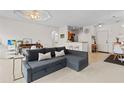 Cozy living room with comfortable seating and easy access to the kitchen and dining area at 2765 Via Cipriani # 1232B, Clearwater, FL 33764