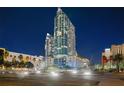 Stunning high-rise condo building exterior with modern architecture, palm trees, and beautifully lit grounds at 777 N Ashley Dr # 2503, Tampa, FL 33602