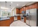 A view of the kitchen complete with stainless steel appliances, granite countertops and tile flooring at 12537 Silverdale St, Tampa, FL 33626