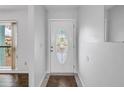 Bright entryway featuring a decorative glass front door and neutral tile flooring at 13851 102Nd Ave, Largo, FL 33774