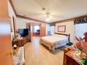 Cozy bedroom featuring matching wood furniture, a ceiling fan, and neutral-toned flooring and walls at 3020 Moss Hill St, Wesley Chapel, FL 33543
