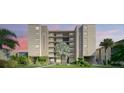 Beautiful condo building with manicured landscaping and palm trees at 19725 Gulf Blvd # 405, Indian Shores, FL 33785