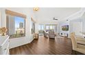 Bright living room with wood floors, neutral decor, and large windows offering city views at 1209 E Cumberland Ave # 505, Tampa, FL 33602