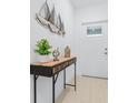 Bright entryway featuring a decorative table with artful accents and sailboat wall decor at 31349 Cabana Rye Ave, San Antonio, FL 33576