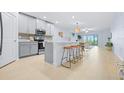 Modern kitchen boasts stainless appliances, barstool seating, and an open layout to the living area at 31349 Cabana Rye Ave, San Antonio, FL 33576