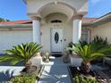 Charming home exterior featuring a well-manicured front yard and decorative lion statues at entrance at 6190 107Th N Ave, Pinellas Park, FL 33782