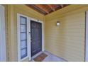 Condo entrance with front door, small window and 'Keys, Phone, Wallet, Glasses' doormat at 8609 Mallard Reserve Dr # 103, Tampa, FL 33614