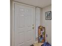 Condo entrance featuring a white front door, coat rack and wall art at 8609 Mallard Reserve Dr # 103, Tampa, FL 33614