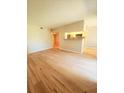 Spacious living room featuring hardwood floors and an open layout with bar into the kitchen at 8609 Mallard Reserve Dr # 103, Tampa, FL 33614