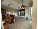 Bright living room with an open floor plan, ceiling fan, and sliding glass door at 1530 Davenport Dr, New Port Richey, FL 34655