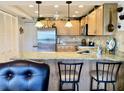 Charming kitchen featuring granite counters, stainless steel appliances, and classic pendant lighting at 1655 S Highland Ave # J193, Clearwater, FL 33756