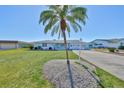 Charming light blue single-story home with lush green lawn at 1806 Burlington Cir, Sun City Center, FL 33573