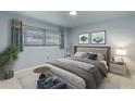 This bedroom has a gray bed frame, light blue walls, and hardwood flooring at 1903 Oro Ct, Clearwater, FL 33764