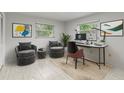 This home office features two chairs, dual monitors, and artwork at 1903 Oro Ct, Clearwater, FL 33764