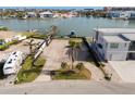 Waterfront lot ready for your new home, complete with driveway and mature landscaping at 211 Bath Club N Blvd, North Redington Beach, FL 33708