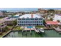 Stunning aerial view of waterfront home with a pool, docks, and ocean views at 11721 1St E St, Treasure Island, FL 33706