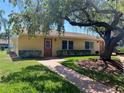 Charming single-story home with well-maintained landscaping and a welcoming walkway to the front door at 401 Dorchester Pl # 62, Sun City Center, FL 33573