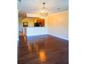 Open-concept living space with hardwood floors and a view into the kitchen area at 10217 Westpark Preserve Blvd, Tampa, FL 33625