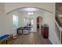 Spacious living area showcasing the staircase, luxury vinyl floors and open archways at 18311 Arbor Crest Dr, Hudson, FL 34667