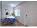 Cozy dining area featuring a round table with chairs, a window, and a door at 18325 Gulf Blvd # 405, Redington Shores, FL 33708