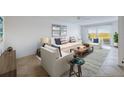 Bright living room featuring a sofa, armchairs, neutral walls, area rug, and sliding doors to the balcony at 18325 Gulf Blvd # 405, Redington Shores, FL 33708