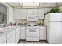 Cozy kitchen featuring white appliances, tile backsplash and ample counter space at 4732 Lake Blvd # A, Clearwater, FL 33762