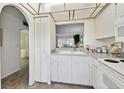 Functional kitchen with a view to other rooms, featuring white appliances and plenty of storage at 4732 Lake Blvd # A, Clearwater, FL 33762