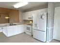 Bright kitchen with white appliances, tiled floors and ample countertop space for cooking and entertaining at 1311 Caloosa Lake Ct, Sun City Center, FL 33573