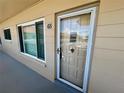 Unit 65 featuring front door and window on walkway at 2311 Brisbane St # 65, Clearwater, FL 33763