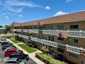 Multi-story condo building showing parking, decorative balconies and landscaping at 2311 Brisbane St # 65, Clearwater, FL 33763