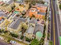 Aerial view of a neighborhood with colorful townhomes, roof patios and a community swimming pool at 2419 Victoria Gardens Ln, Tampa, FL 33609