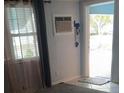 Entryway with natural light from a window and an open door leading to the outside at 8501 47Th N St, Pinellas Park, FL 33781