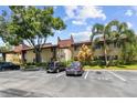 A well-maintained building with reserved parking spaces and mature trees in Village Lake Condominiums at 880 S Village Lake N Dr # 106, St Petersburg, FL 33716