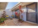 Cozy brick courtyard with patio furniture and colorful tropical plants at 1304 Pasadena S Ave # 3, South Pasadena, FL 33707