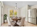 Bright dining area features tile flooring, a modern light fixture, and a view of the backyard at 4251 Whittner Dr, Land O Lakes, FL 34639