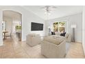 Bright and airy living room with vaulted ceiling, neutral decor, and large window views of backyard at 4251 Whittner Dr, Land O Lakes, FL 34639