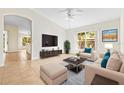 Bright living room featuring a large window, neutral furniture, and modern entertainment center at 4251 Whittner Dr, Land O Lakes, FL 34639