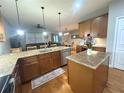 Open kitchen featuring granite countertops, stainless steel appliances, and seamless flow to living and dining areas at 1314 Riserva Ln, Palm Harbor, FL 34683