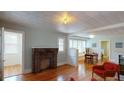 Spacious living room featuring a brick fireplace, hardwood floors, and ample natural light at 2418 2Nd S Ave, St Petersburg, FL 33712