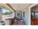 Inviting porch with decorative tile floor, seating, and a view of the neighborhood at 2418 2Nd S Ave, St Petersburg, FL 33712