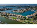 Scenic aerial view of the condo building surrounded by calm water and lush landscaping at 2775 Kipps Colony S Dr # 105, Gulfport, FL 33707