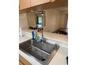 Kitchen sink area featuring a view to the dining room and living room at 829 3Rd Sw Ave # 2, Largo, FL 33770